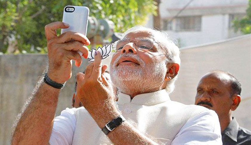 Gujarat High Court recalls order of admitting petition against PM Modi for Poll Code Breach, clicking selfie with BJP Lotus